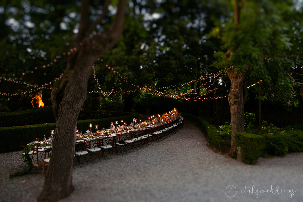 Siena Stomennano wedding evening fairy lights long country table