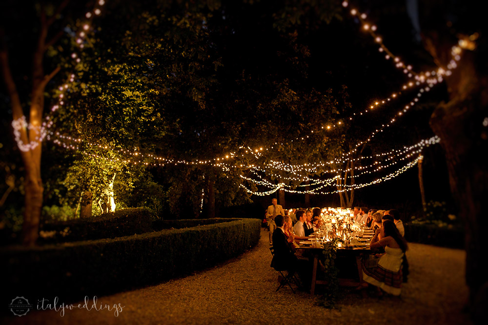 Siena Stomennano wedding evening fairy lights long country table