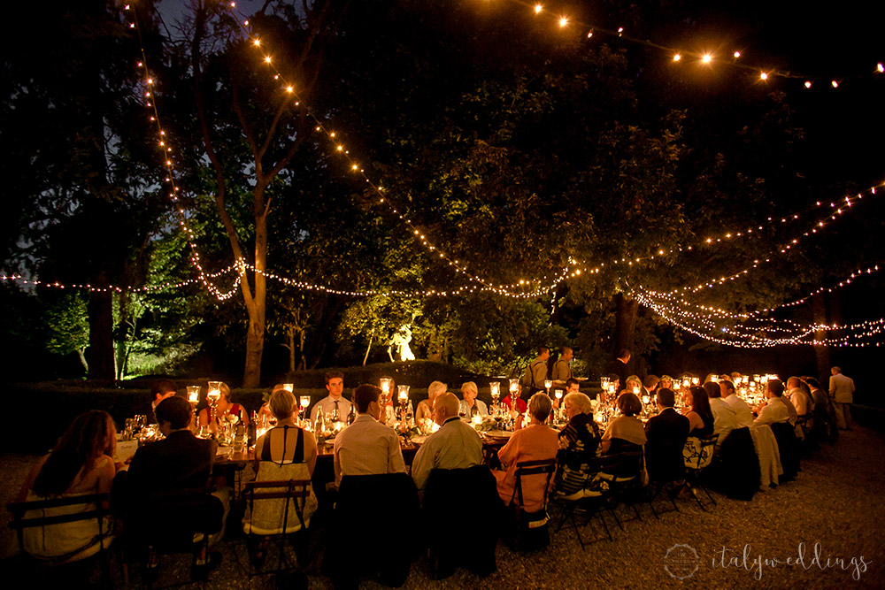 Siena Stomennano wedding evening fairy lights long country table