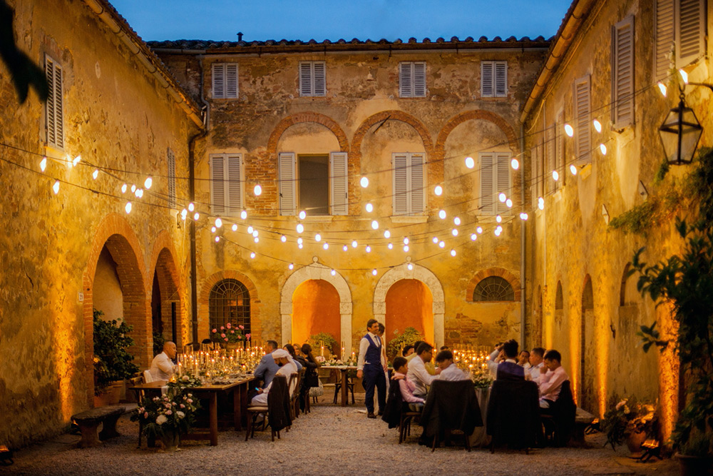 Ema and Enrico international blessing in Pienza Tuscany - bulb lights meal