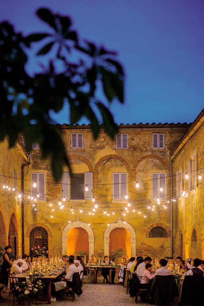 Ema and Enrico international blessing in Pienza Tuscany - bulb lights meal